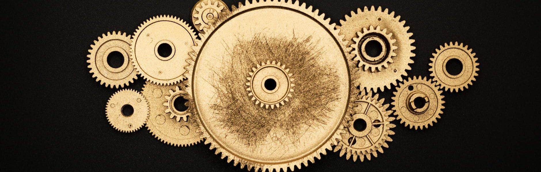photo of golden cogwheel on black background