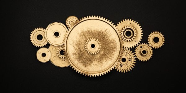 photo of golden cogwheel on black background